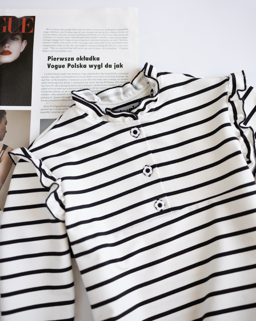 Detail of floral buttons and ruffled neckline on striped girls longsleeve by Alwair Kids