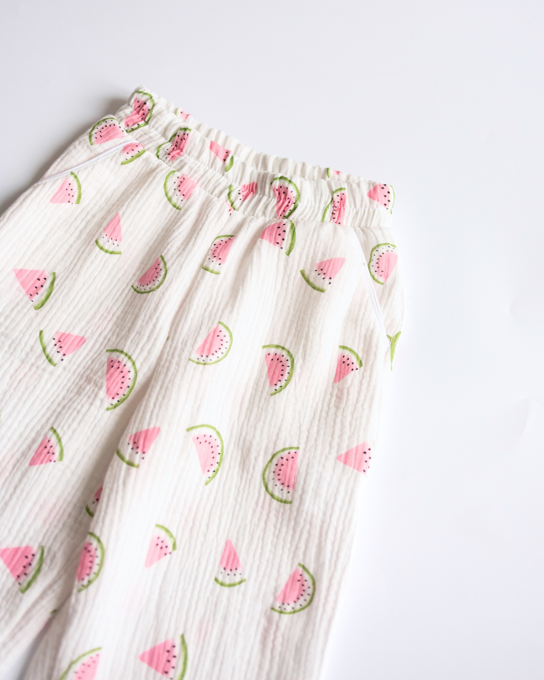Close-up of elastic waistband and soft muslin fabric with watermelon print