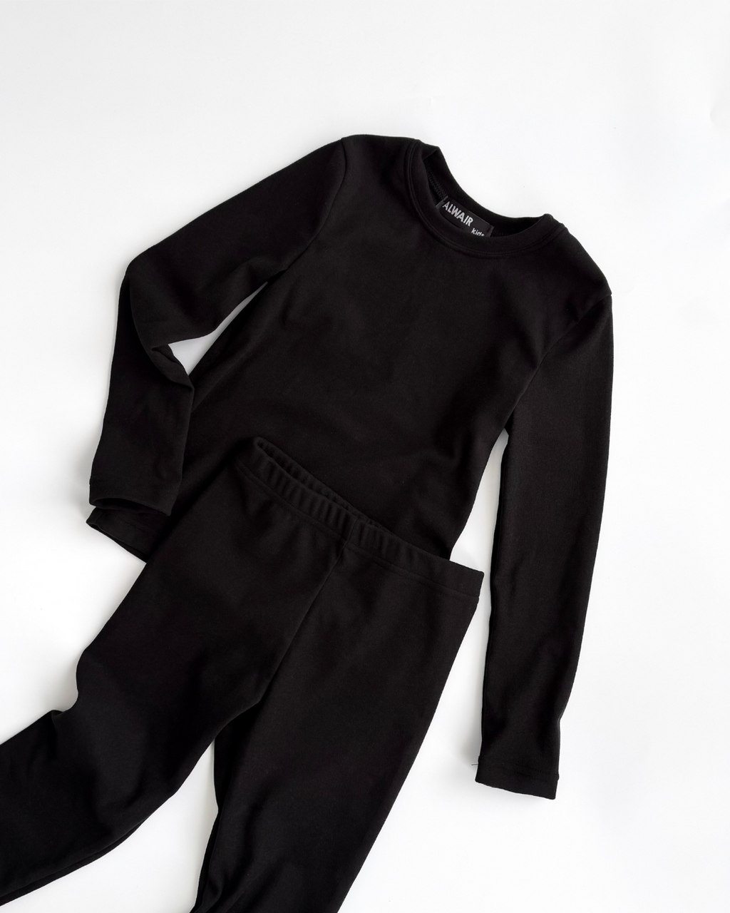 Black thermal underwear set for kids by Alwair Kids flat lay