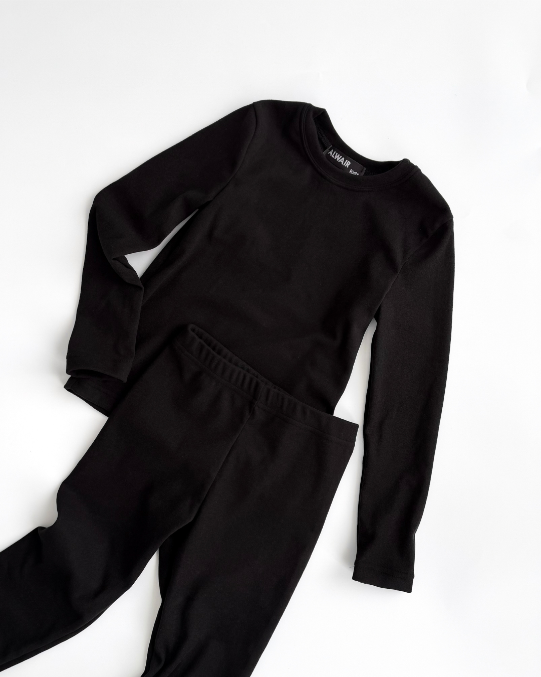Black thermal underwear set for kids by Alwair Kids flat lay