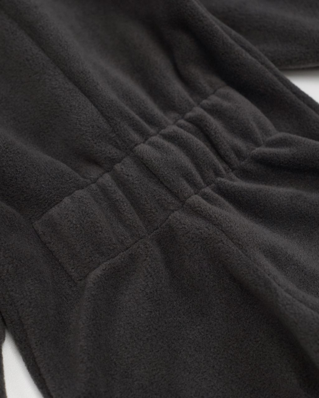 Back elastic waistband detail on charcoal fleece jumpsuit