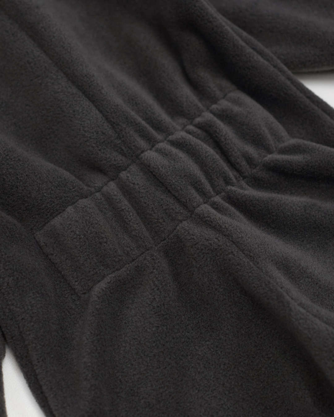 Back elastic waistband detail on charcoal fleece jumpsuit