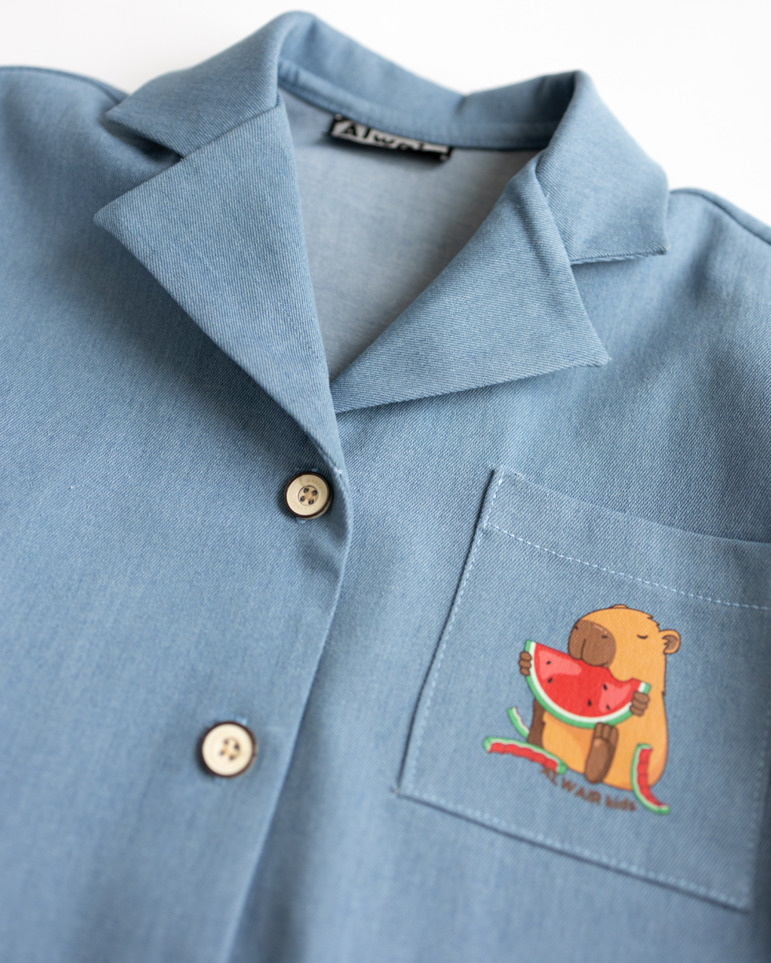 Detail view of collar and buttons on denim capybara shirt for girls – Alwair Kids