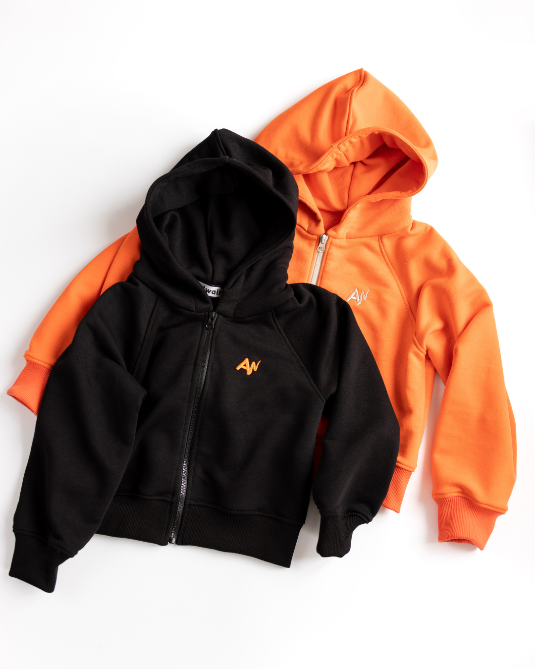 Close-up of black and orange hoodies from Alwair Kids tracksuit set