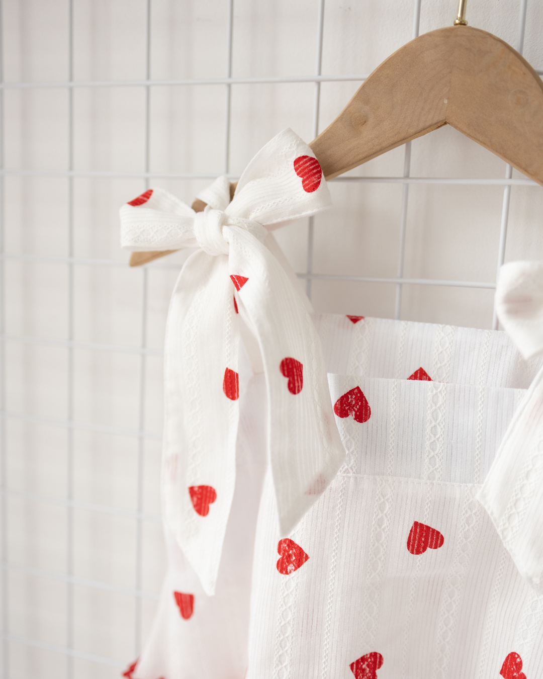 Detailed view of adjustable tie strap with red hearts – Alwair Kids cotton sundress