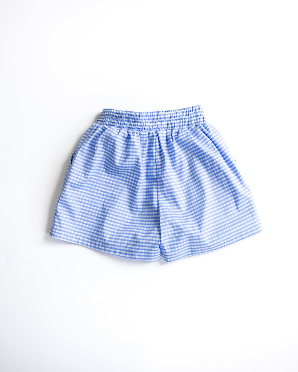 Back view of blue gingham shorts with elastic waistband for girls
