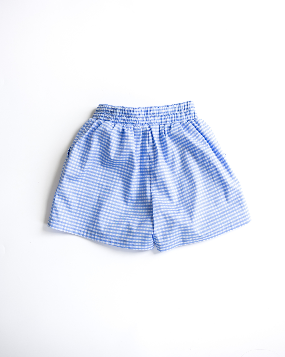 Back view of blue gingham shorts with elastic waistband for girls
