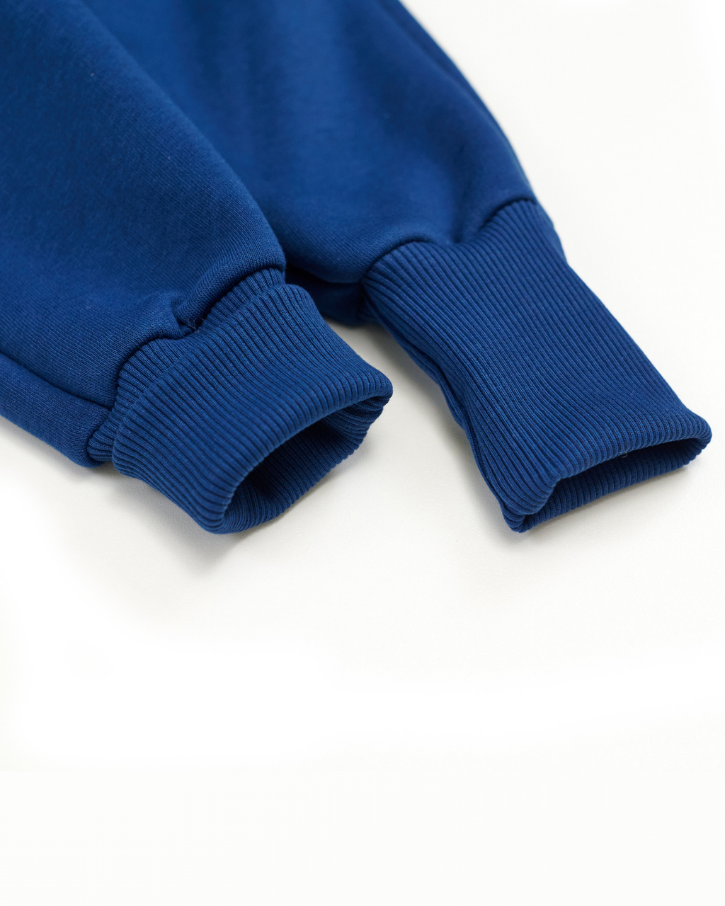 Detailed view of ribbed cuffs on blue fleece kids jumpsuit from Alwair Kids