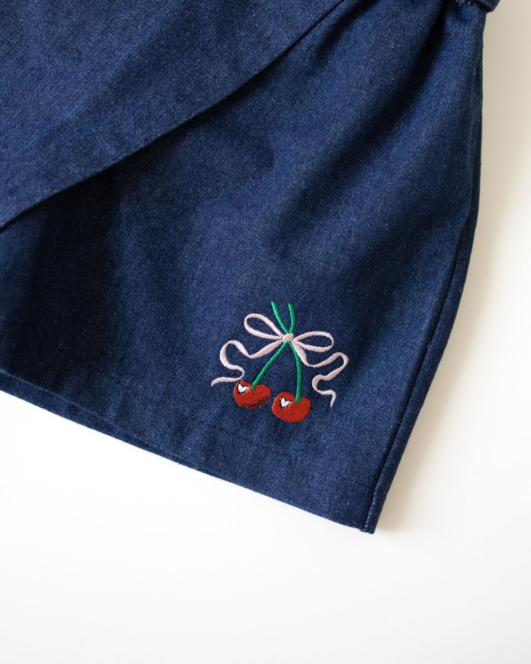 Close-up of cherry embroidery on girls denim skort - Alwair Kids

