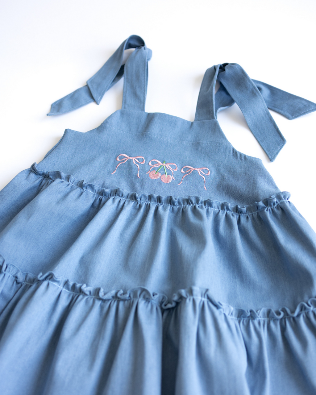 Ruffled skirt detail of girls denim sundress from Alwair Kids
