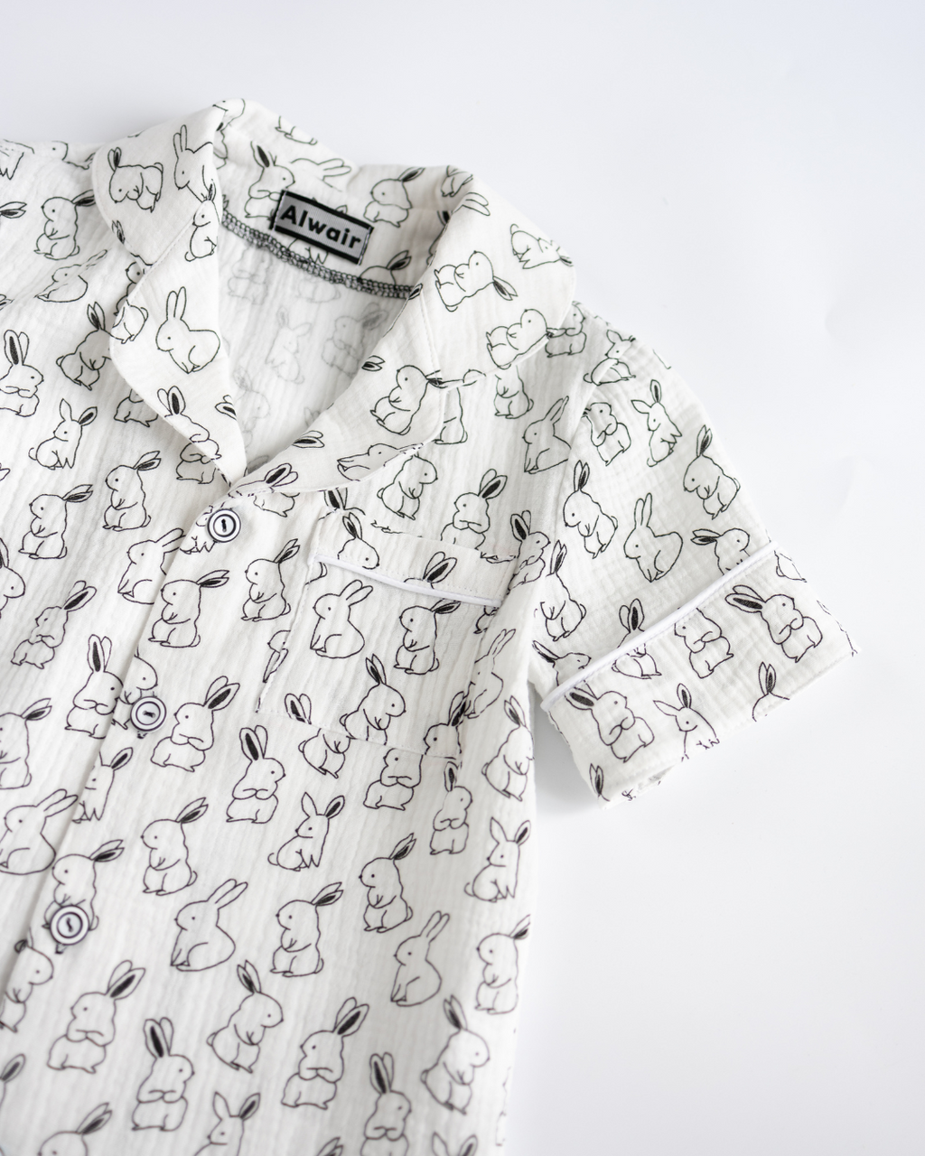 Detail of bunny print collar and pocket on muslin pajama shirt for children