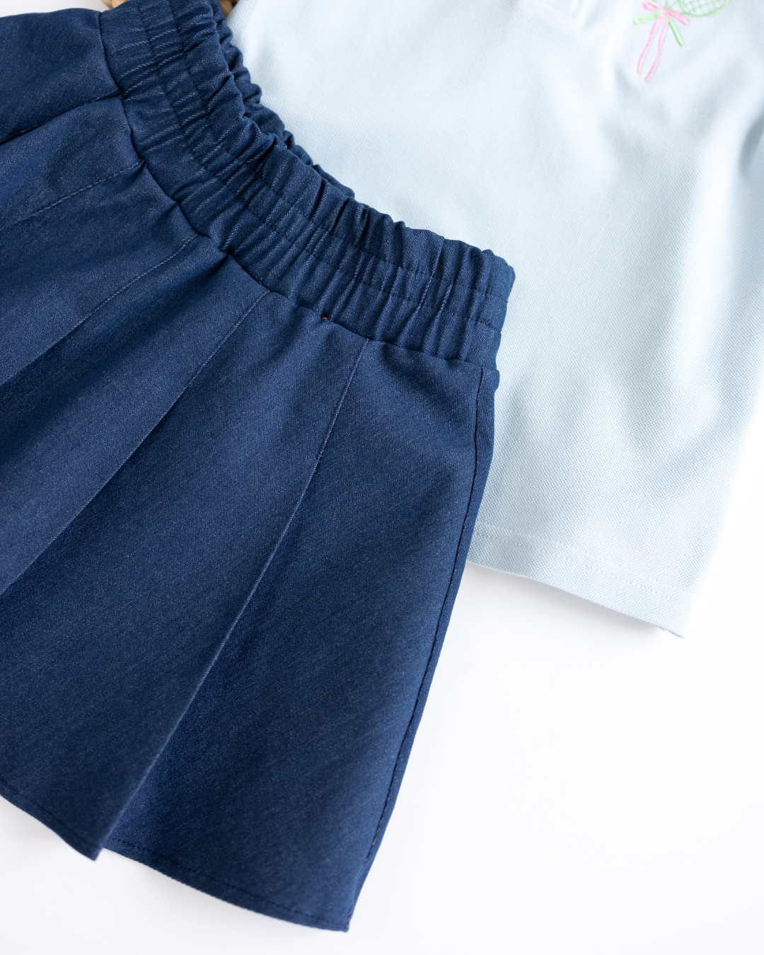 Close-up of elastic waistband and pleats on girls denim tennis skirt by Alwair Kids