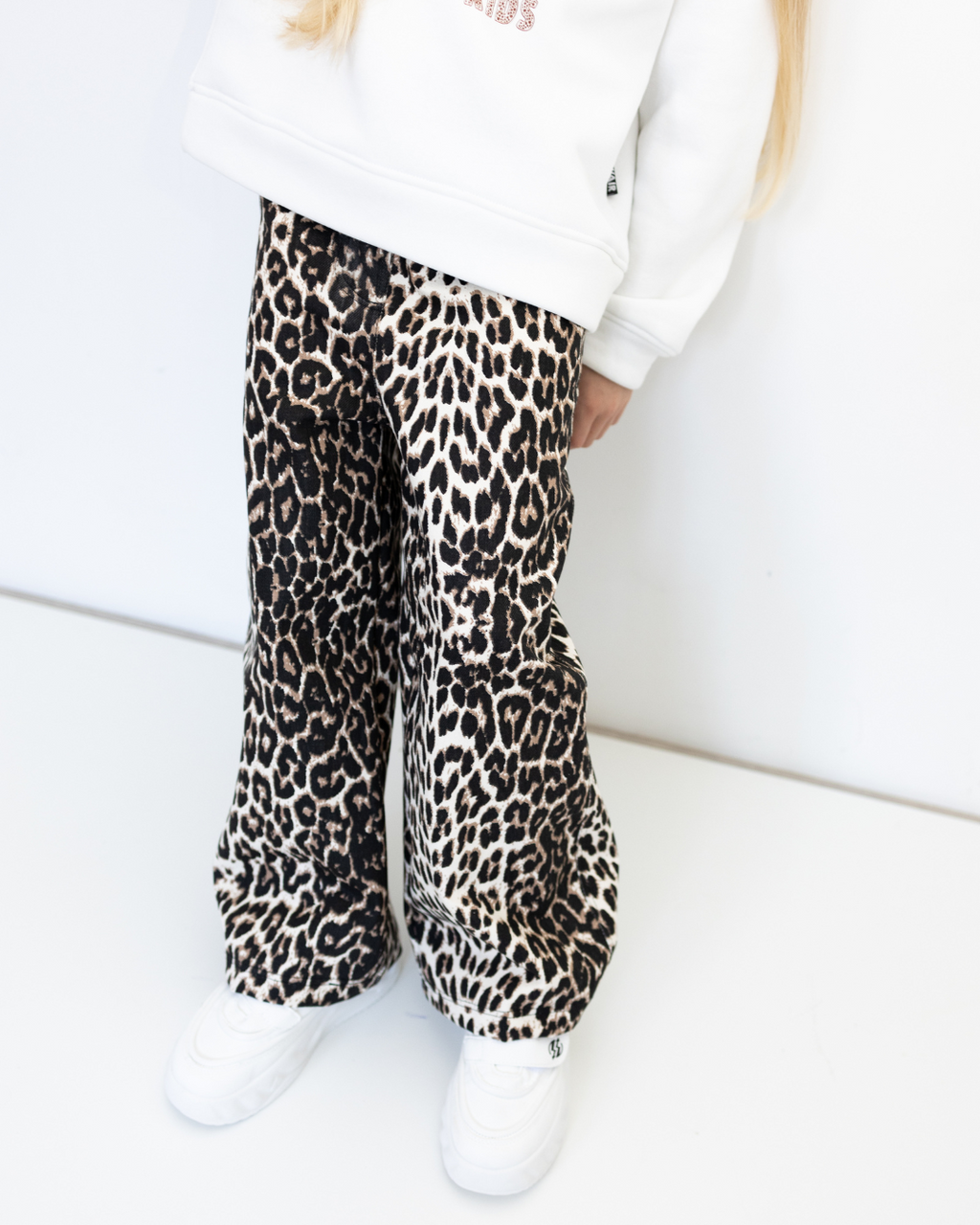 Close-up of leopard print fabric on girls cotton jeans