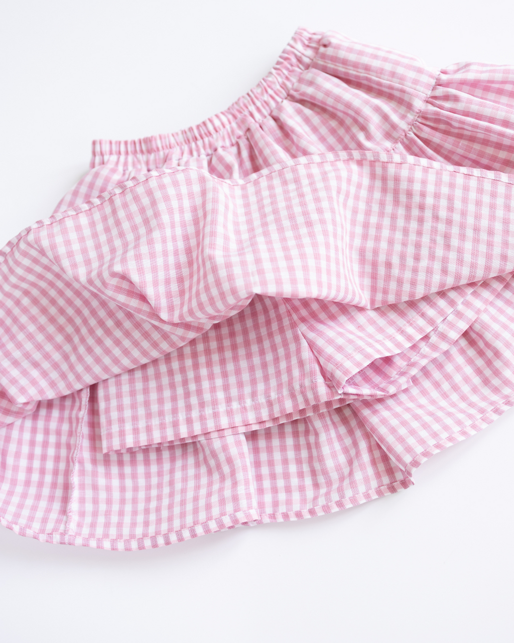 Detail view of inner shorts under gingham skirt from Alwair Kids set