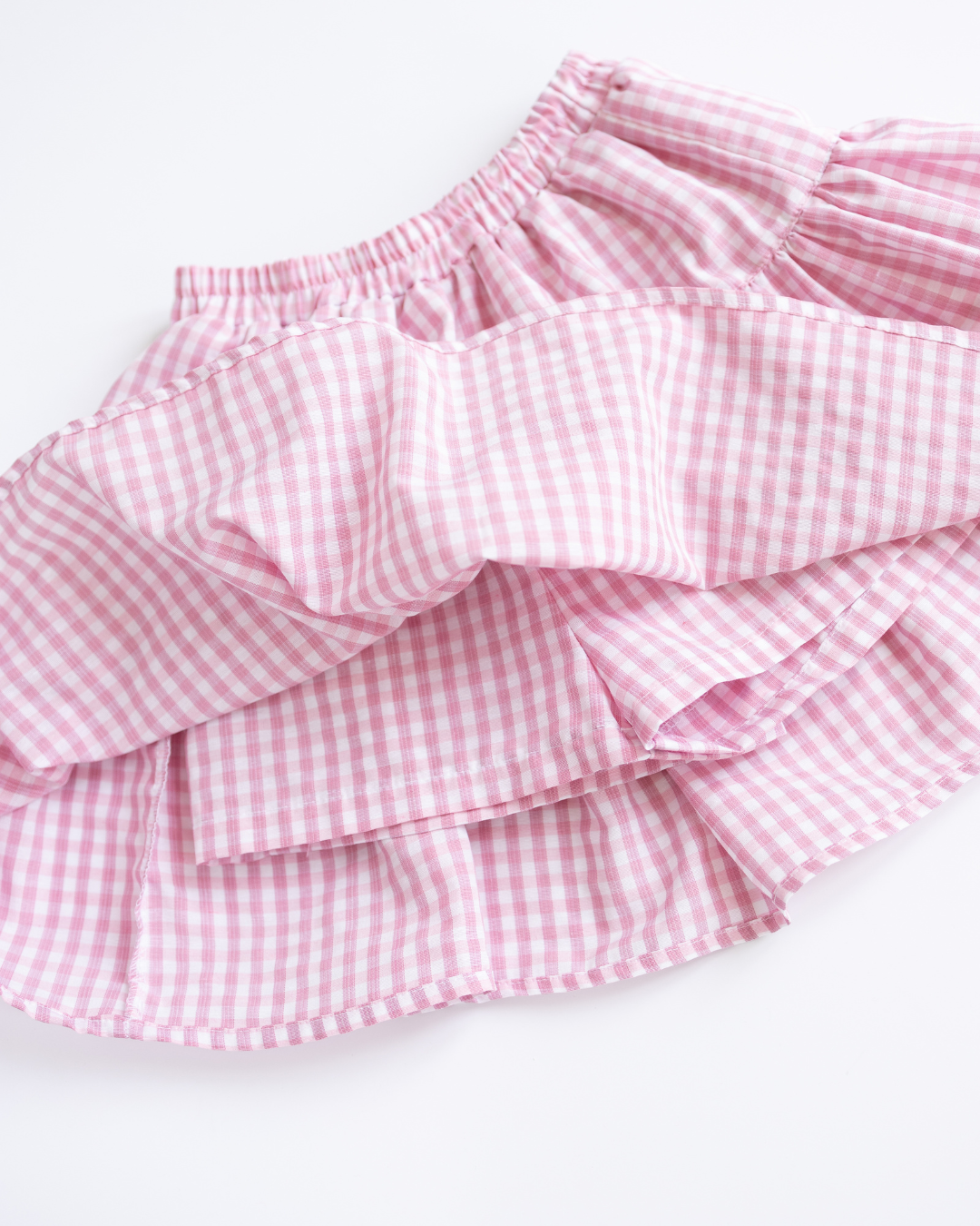 Detail view of inner shorts under gingham skirt from Alwair Kids set