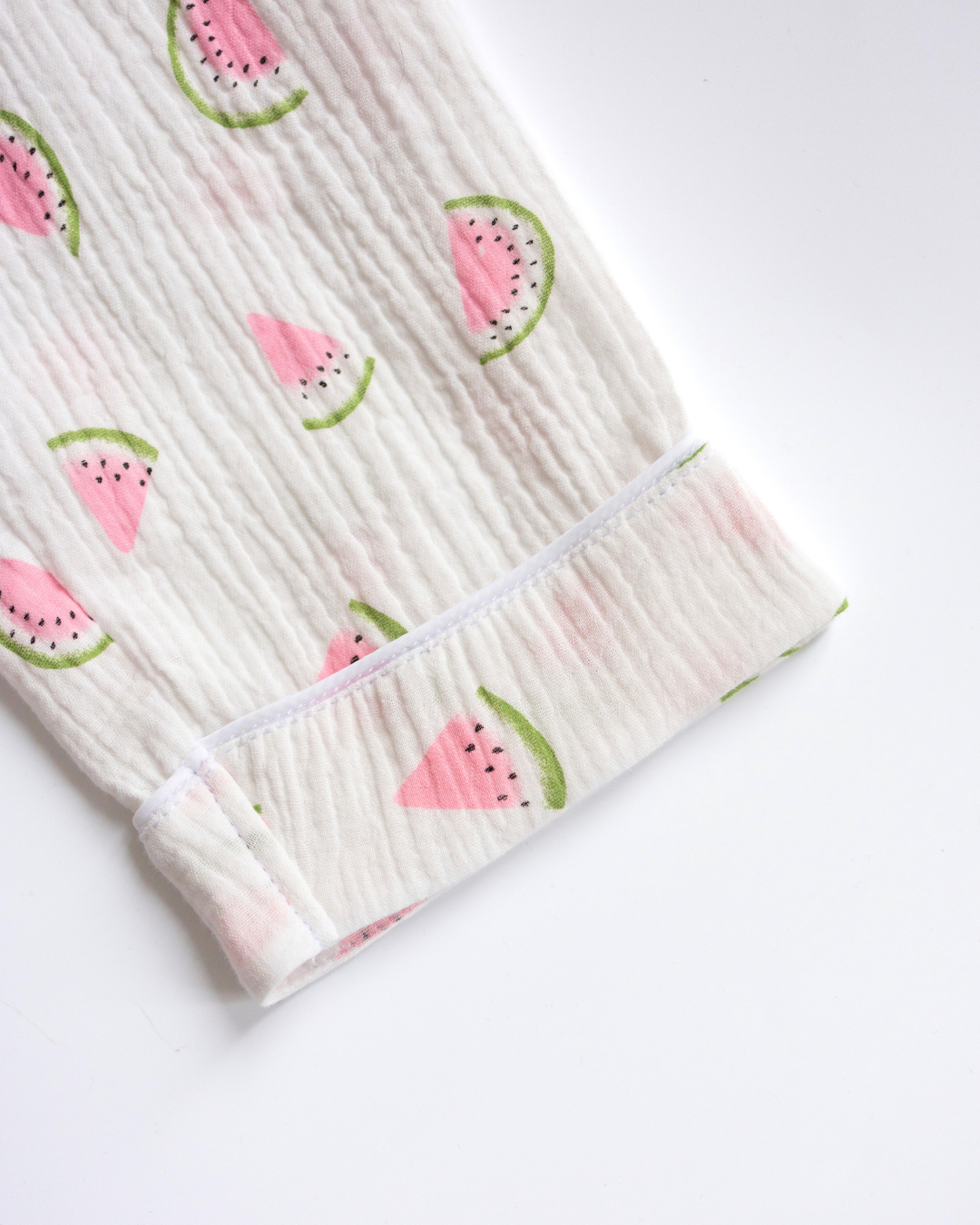 Detail view of pant cuff and watermelon print on girls' muslin pajama set