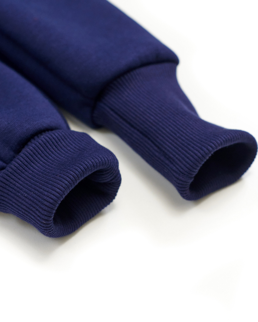 Close-up of ribbed cuffs on navy blue fleece jumpsuit for kids by Alwair