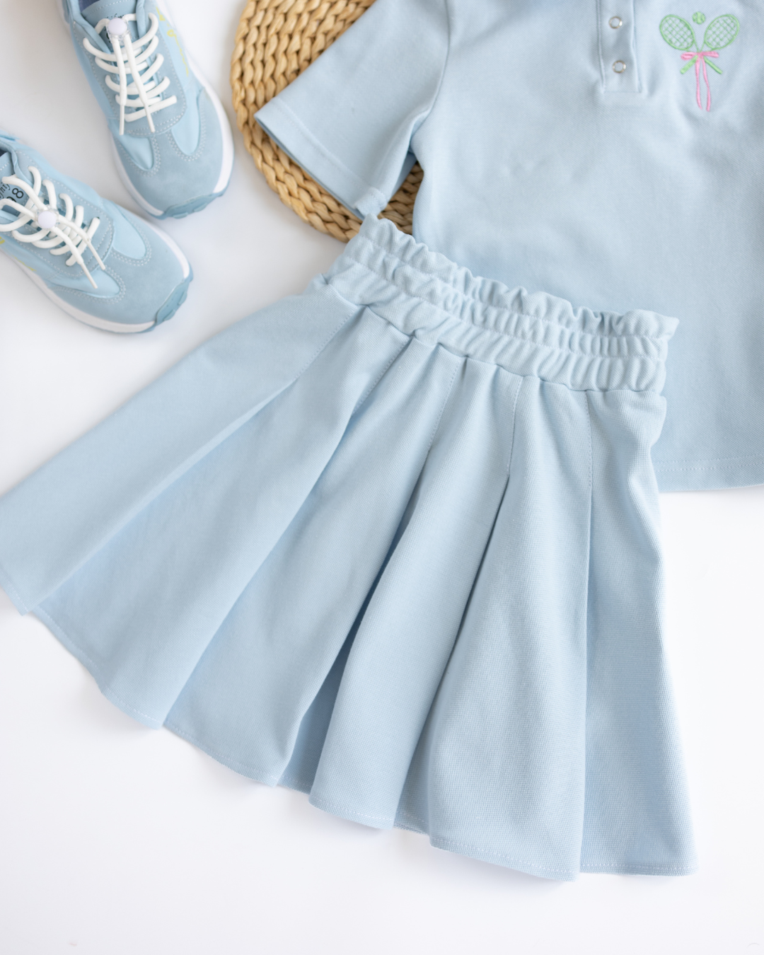 Blue tennis skirt styled with polo shirt and sneakers Alwair Kids