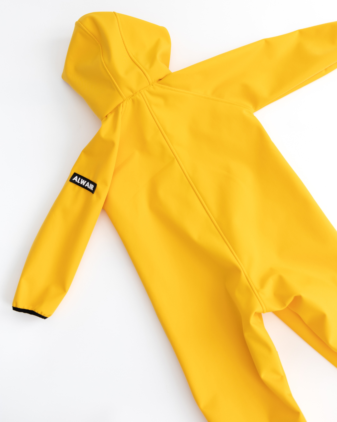 Back of yellow kids softshell overall with Alwair label

