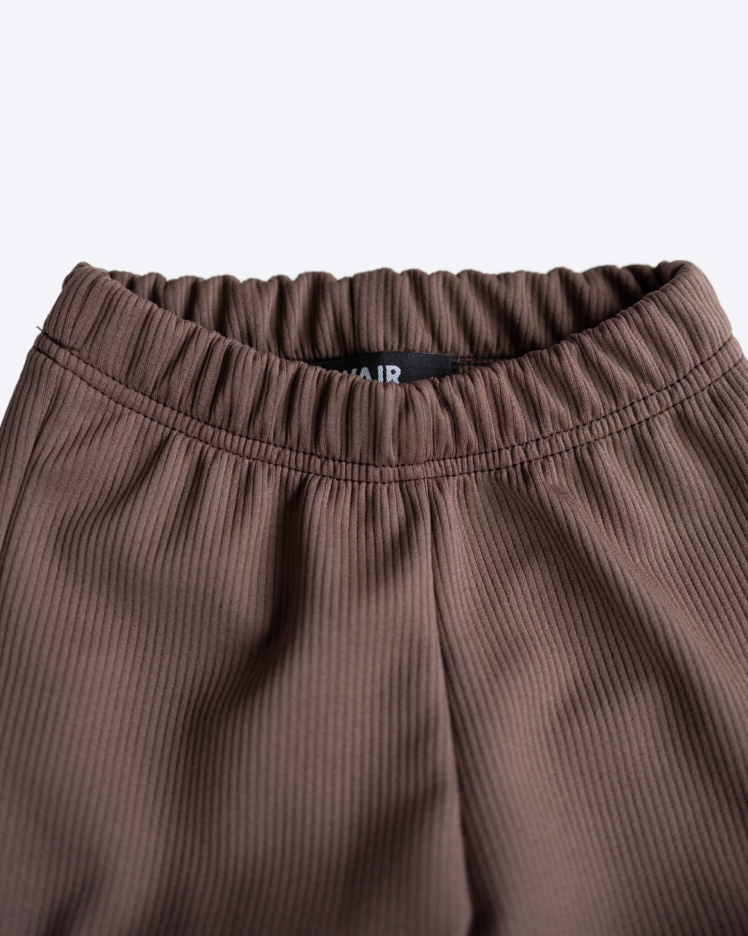 Close-up of elastic waistband on girls ribbed knit leggings Alwair Kids