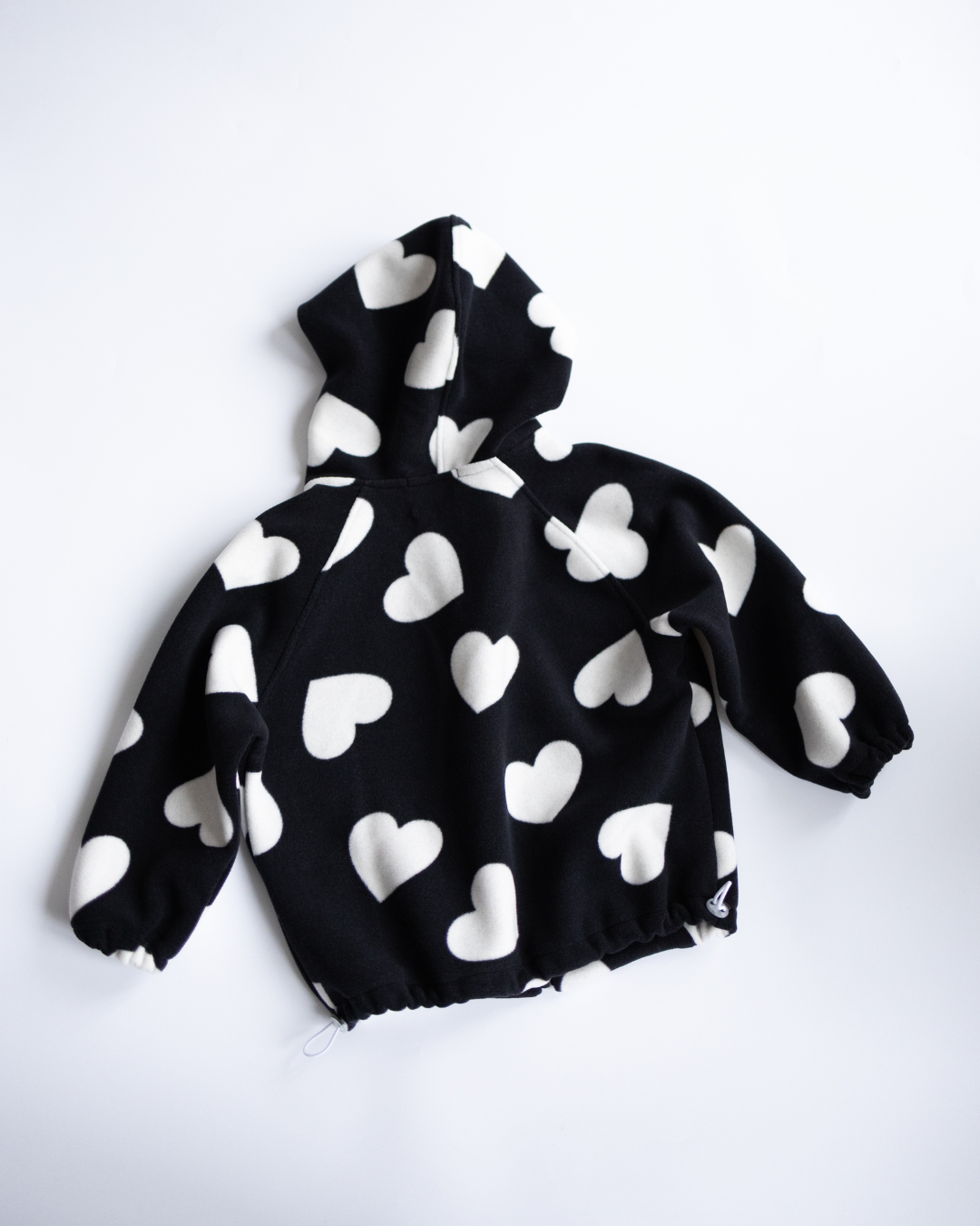 Back side of fleece hoodie with white heart print by Alwair Kids


