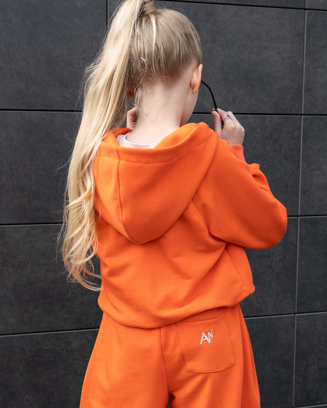 Back view of orange hoodie on girl by Alwair Kids