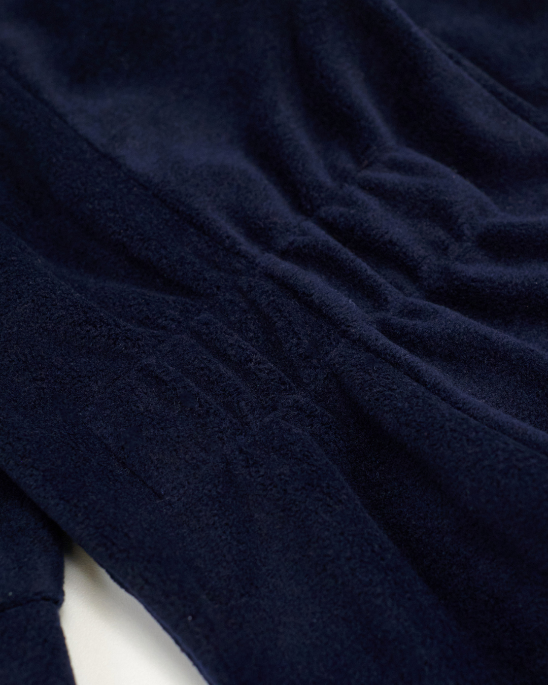 Elastic waistband detail of dark navy fleece jumpsuit – close-up