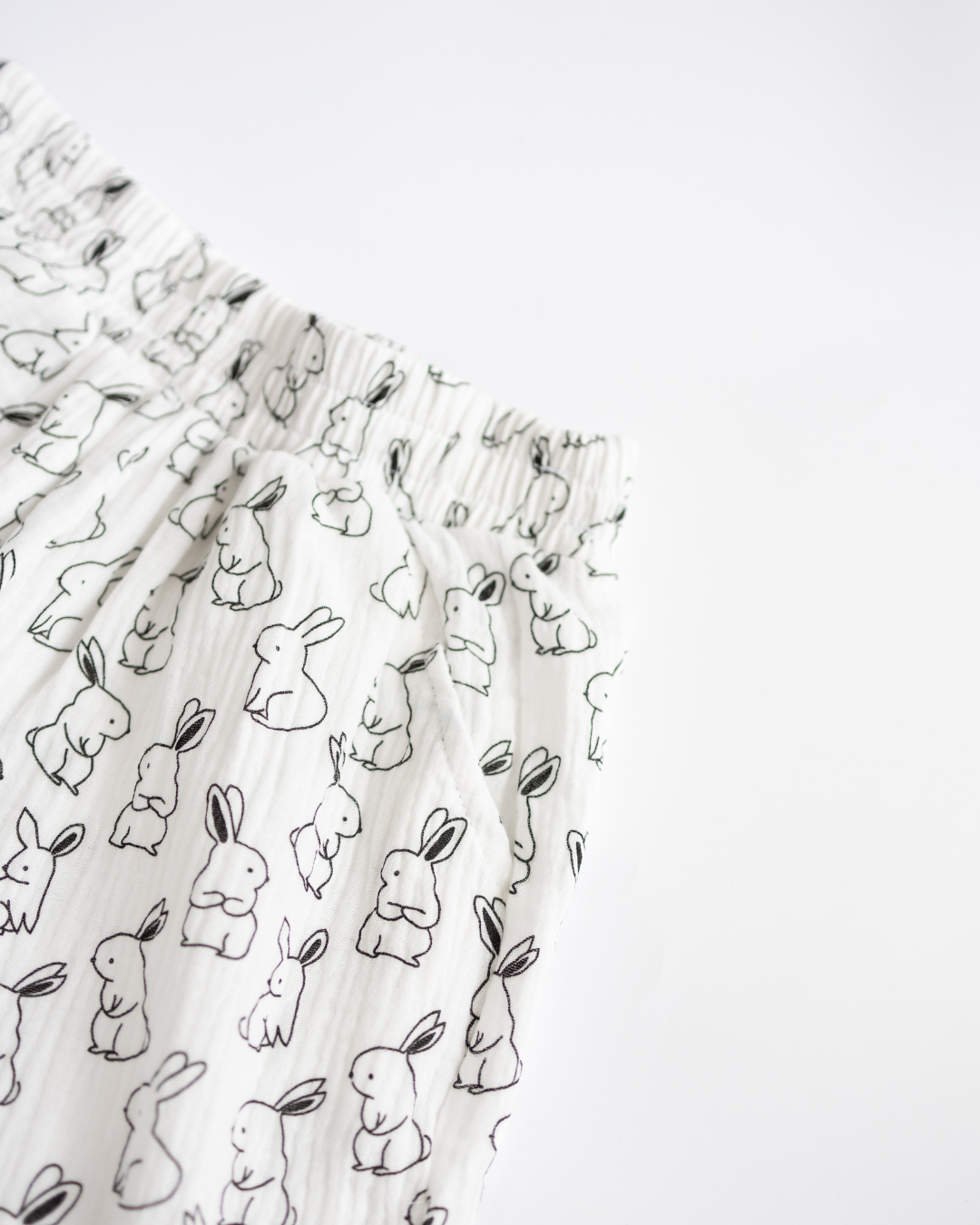 Close-up of soft muslin fabric with black and white bunny print for kids pajama