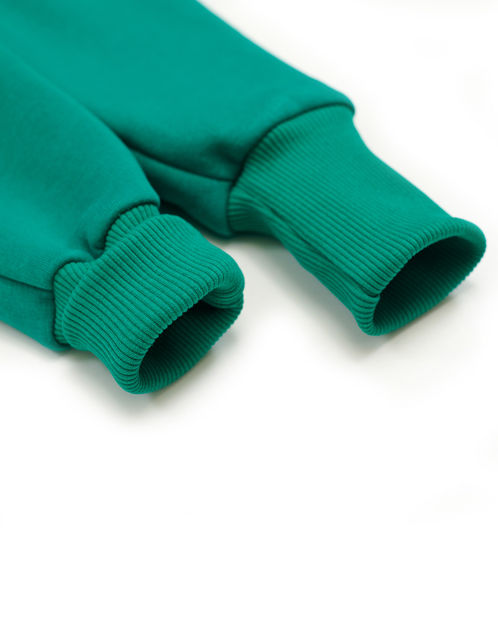 Close-up of ribbed cuffs on green fleece kids jumpsuit by Alwair Kids