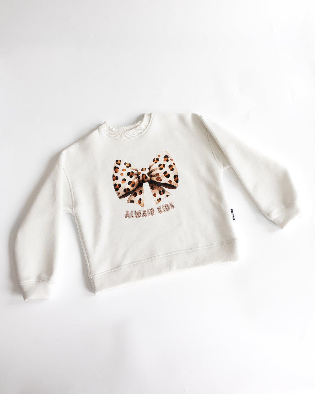 Flat lay of white sweatshirt with leopard bow print Alwair Kids