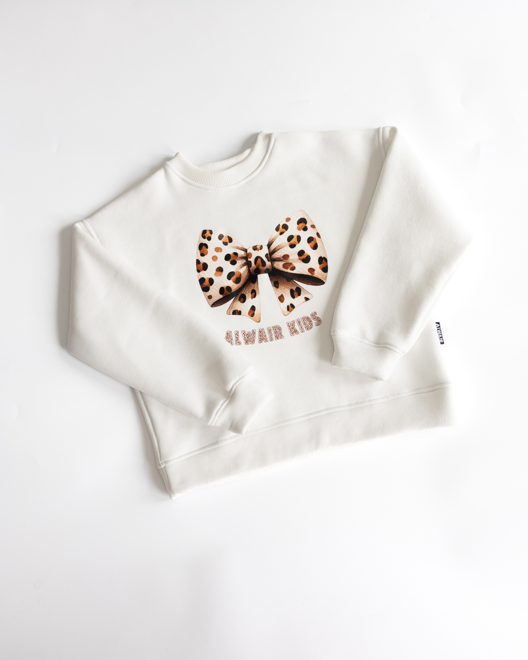 Folded view of sweatshirt with leopard bow print by Alwair Kids