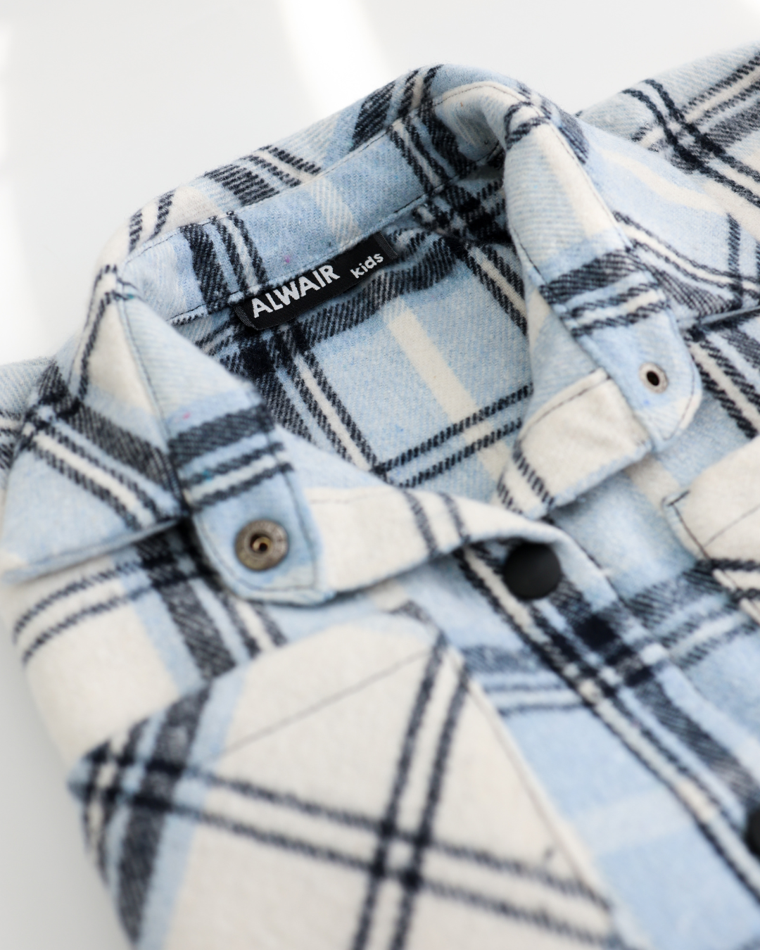 Close-up of collar and button details on cotton plaid shirt Alwair Kids