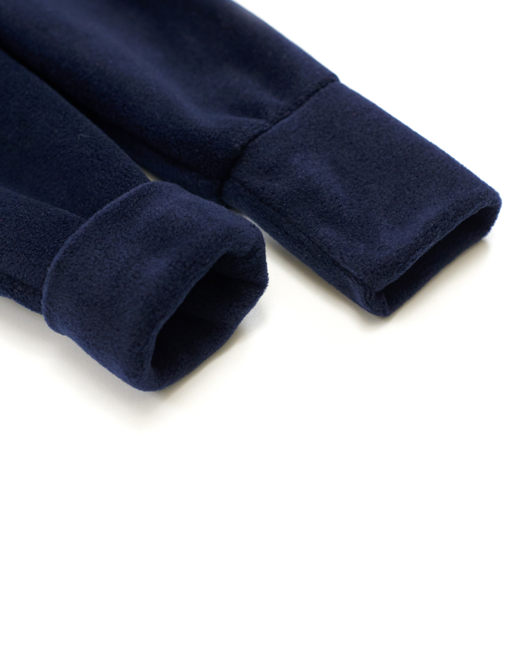 Folded fleece cuffs on dark navy kids jumpsuit – close-up texture