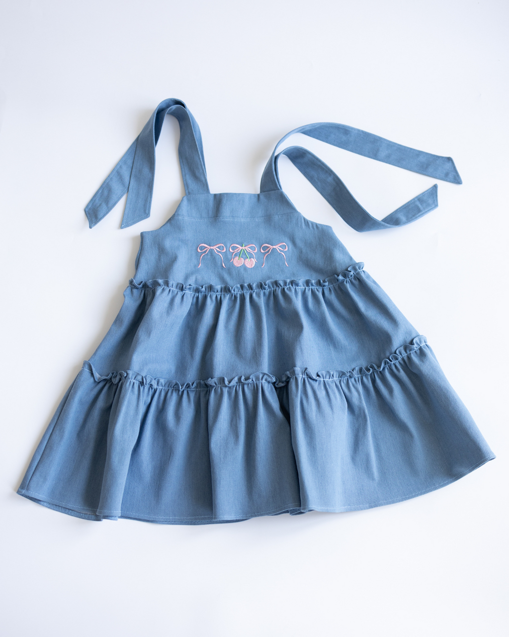 Flat lay of light blue denim sundress for girls by Alwair Kids

