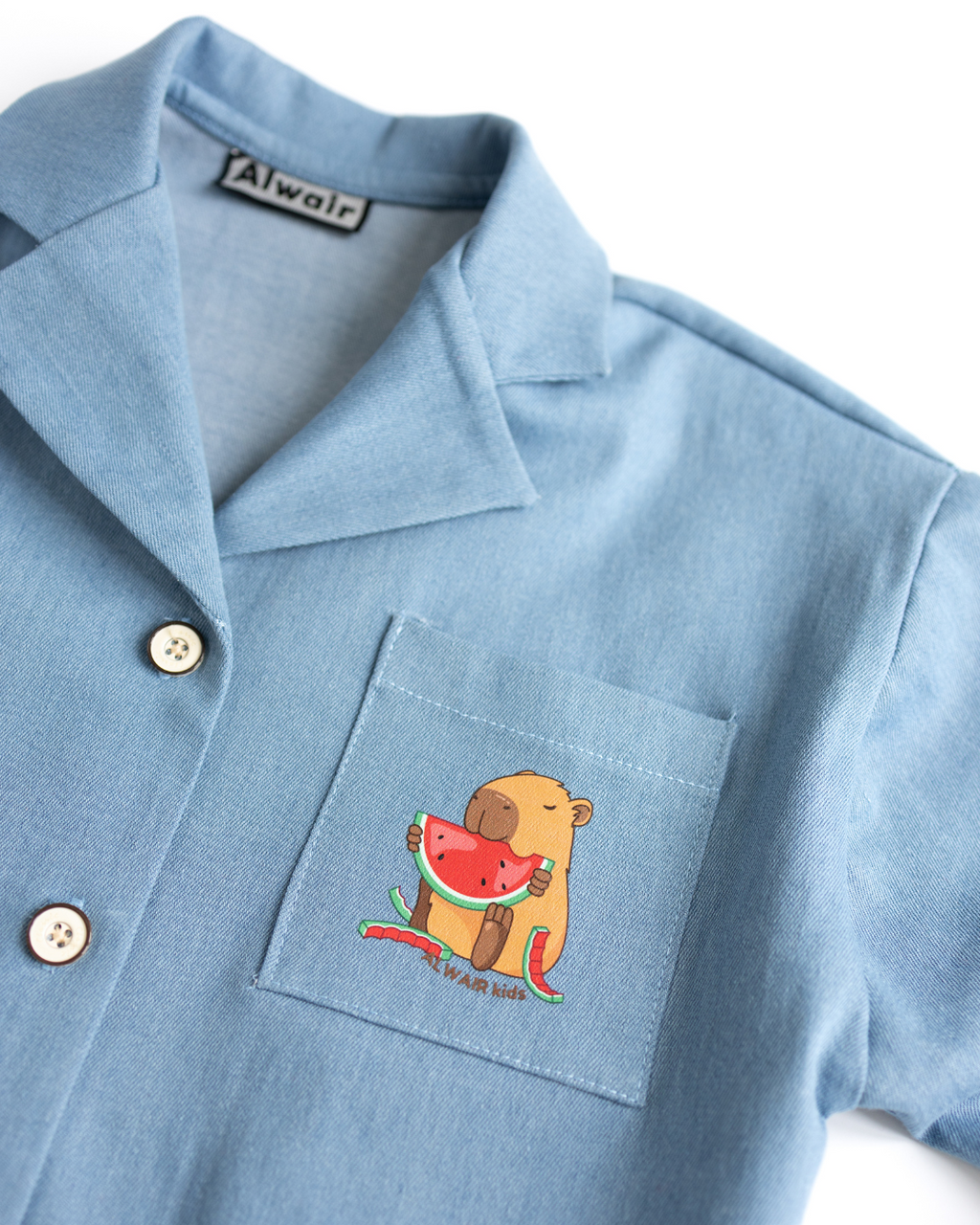 Capybara eating watermelon print detail on girls shirt pocket