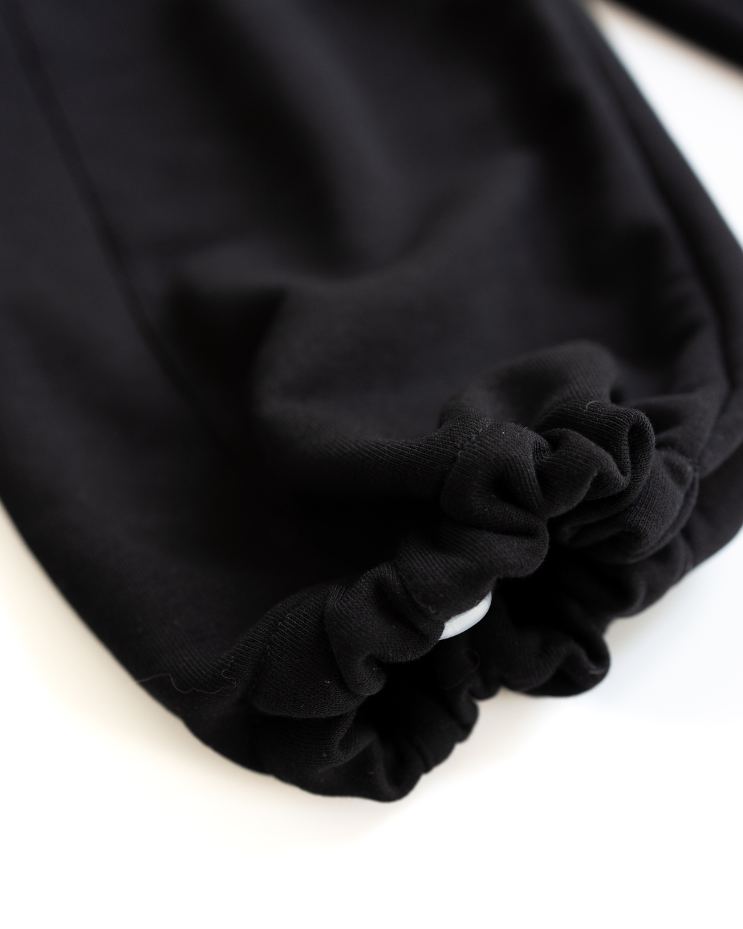 Elasticated drawstring hem on black knit pants by Alwair Kids close-up