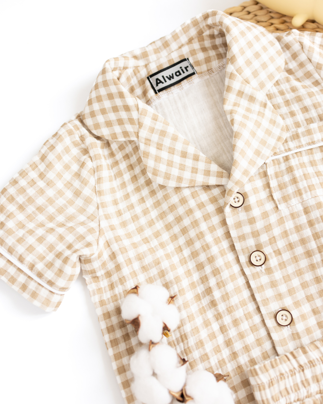 Close-up of cotton fabric and buttons on gingham pajama