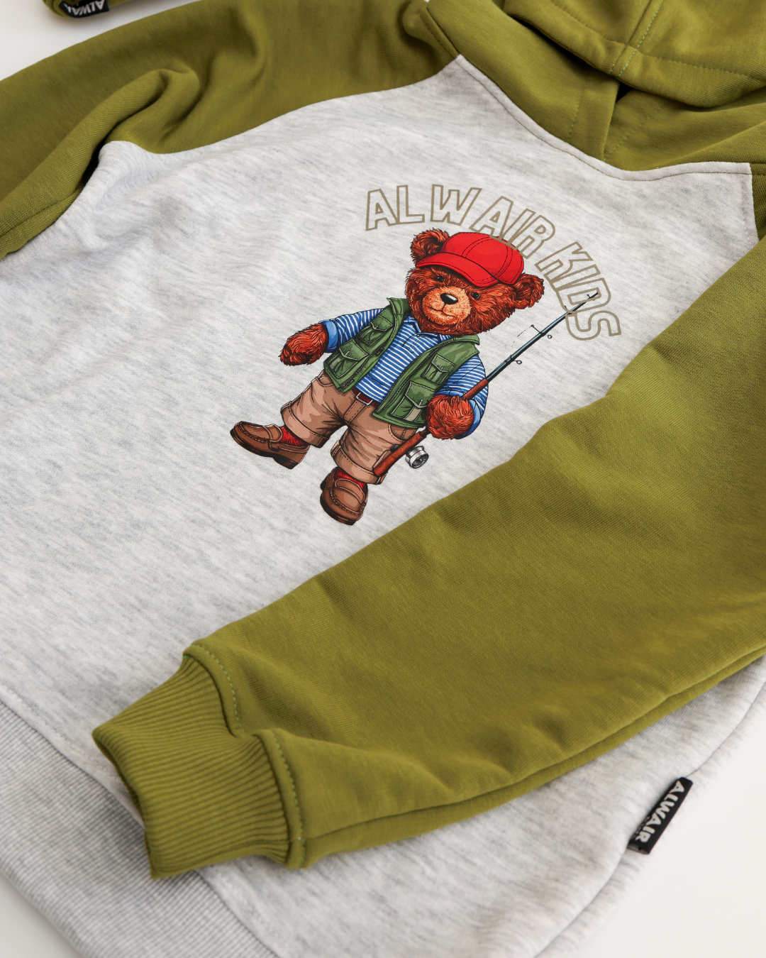 Close-up of green sleeve and teddy fisherman print on Alwair Kids boys hoodie