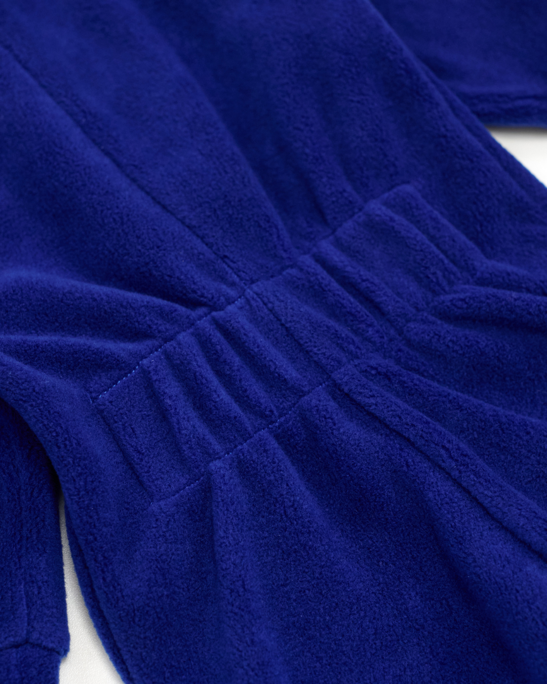 Elastic waistband close-up on navy fleece jumpsuit