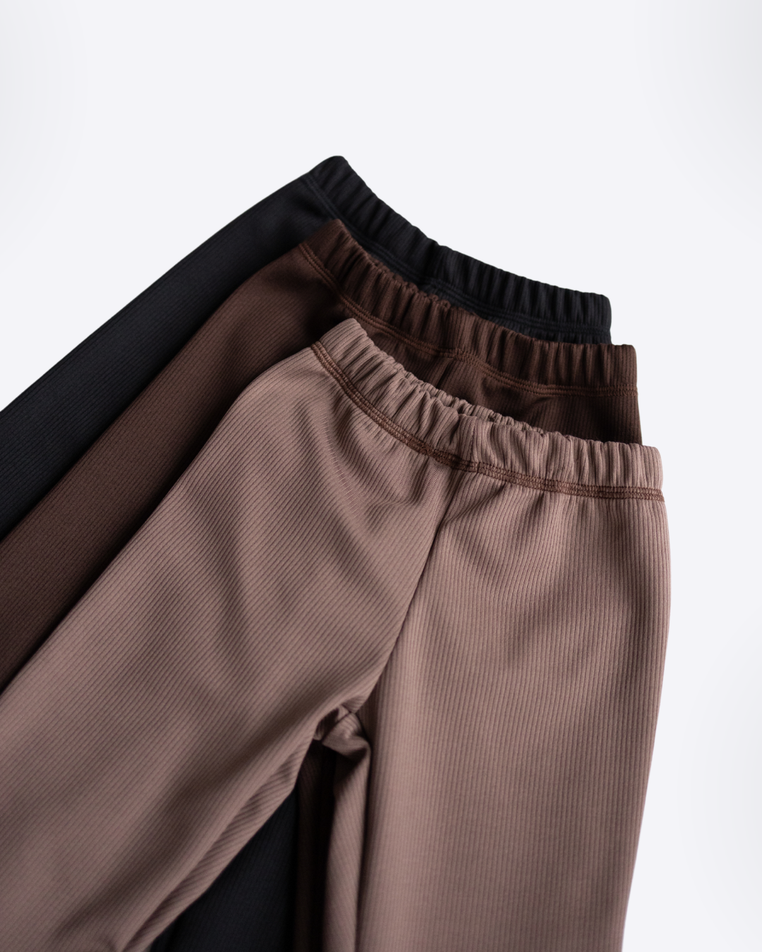 Ribbed knit leggings in beige brown and black stacked together flat lay - Alwair Kids