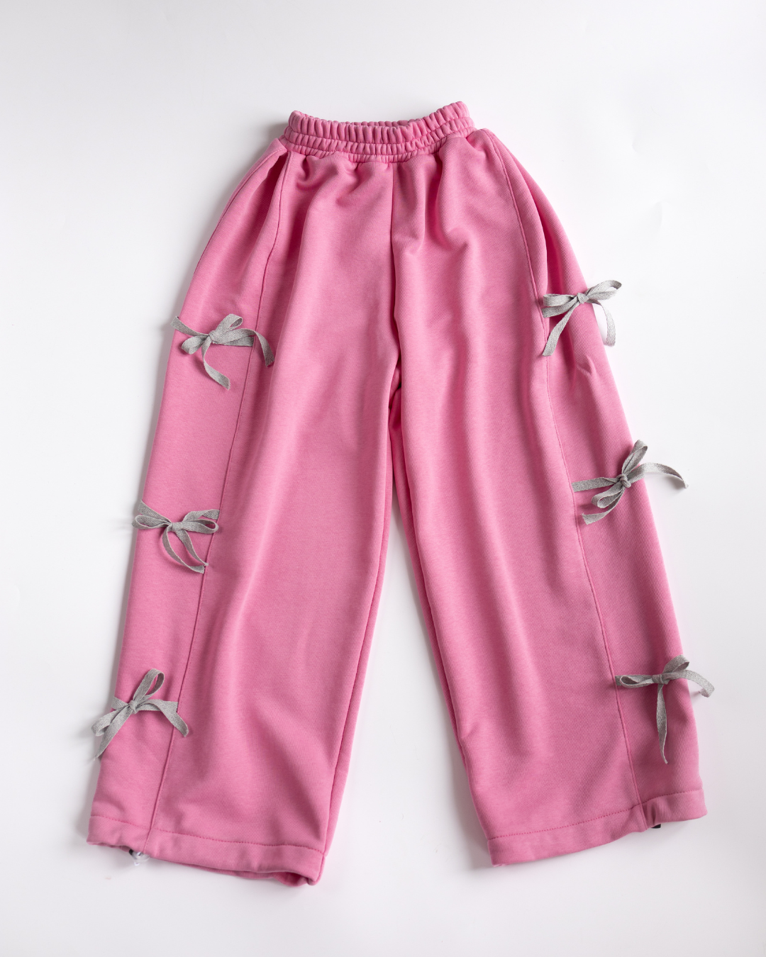 Pink palazzo pants for girls with gray bows by Alwair Kids flat lay photo