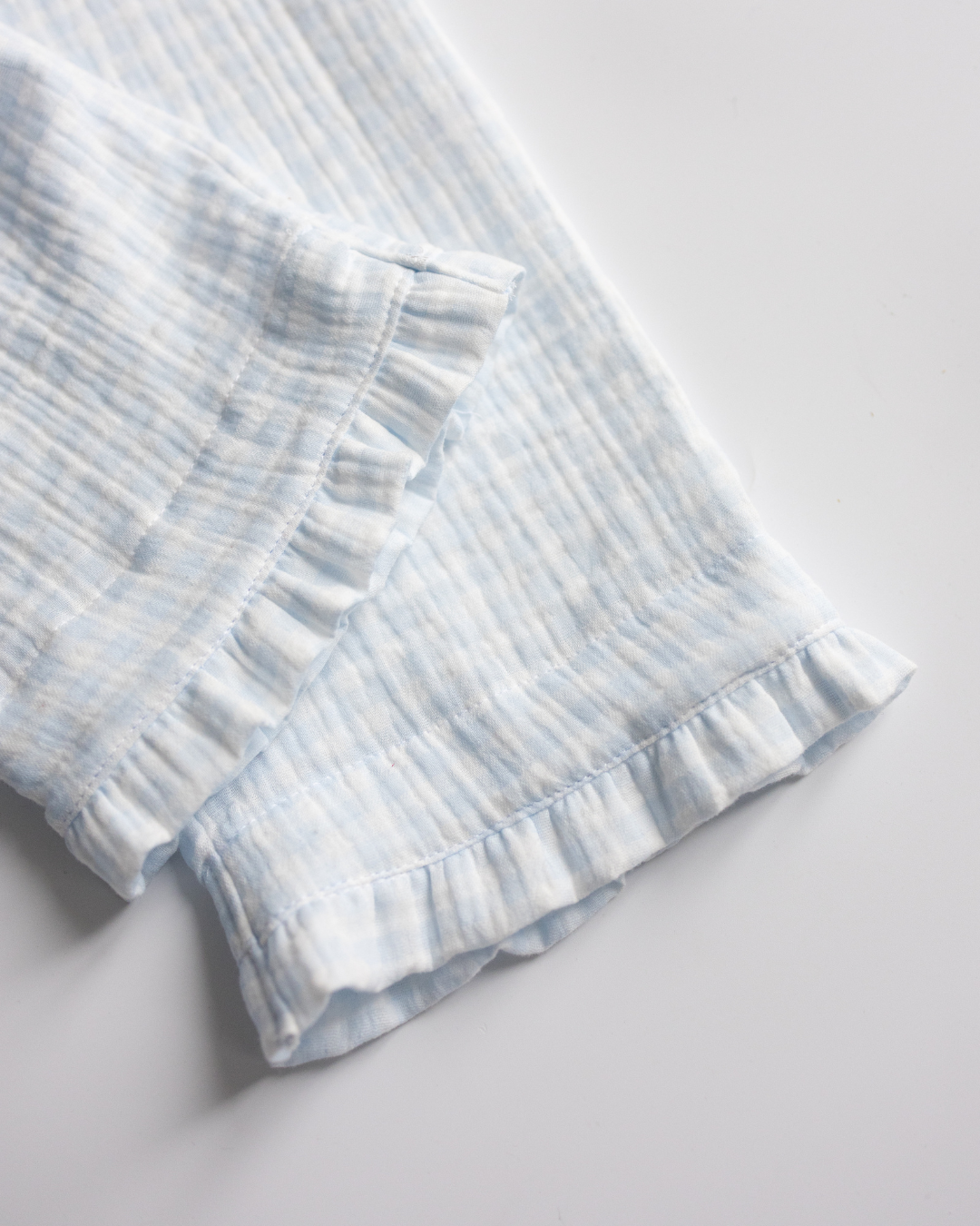 Ruffle hem on girls’ pajama pants in breathable blue muslin cotton