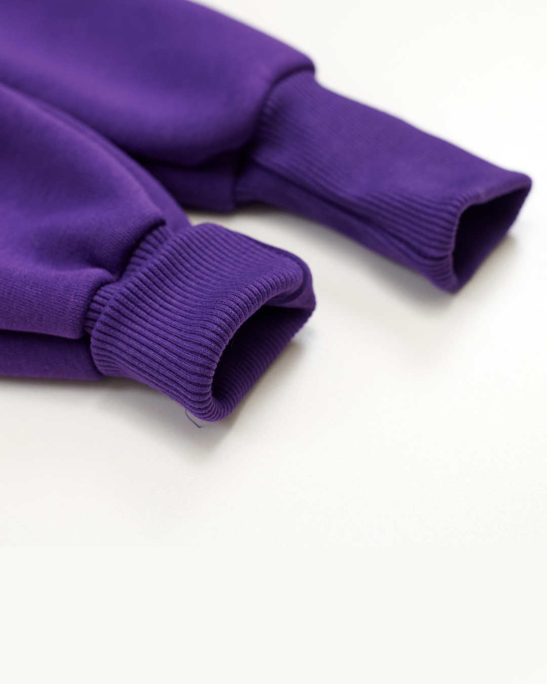 Close-up of ribbed cuffs on purple fleece jumpsuit for kids from Alwair Kids