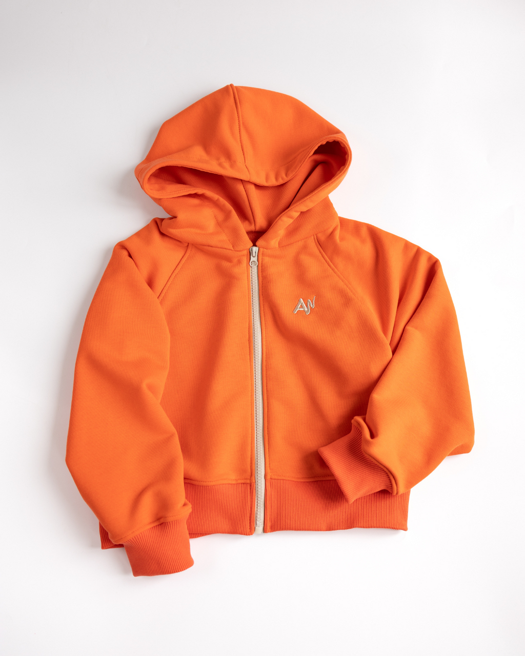 Flat lay orange zip hoodie for girls by Alwair Kids
