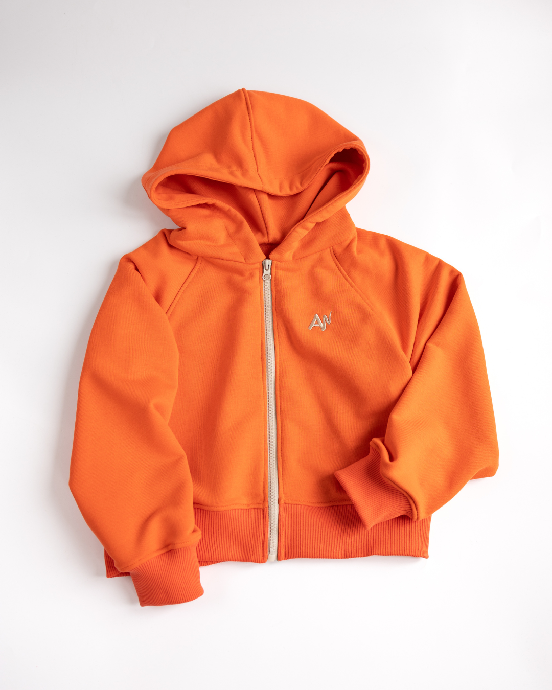 Flat lay orange zip hoodie for girls by Alwair Kids