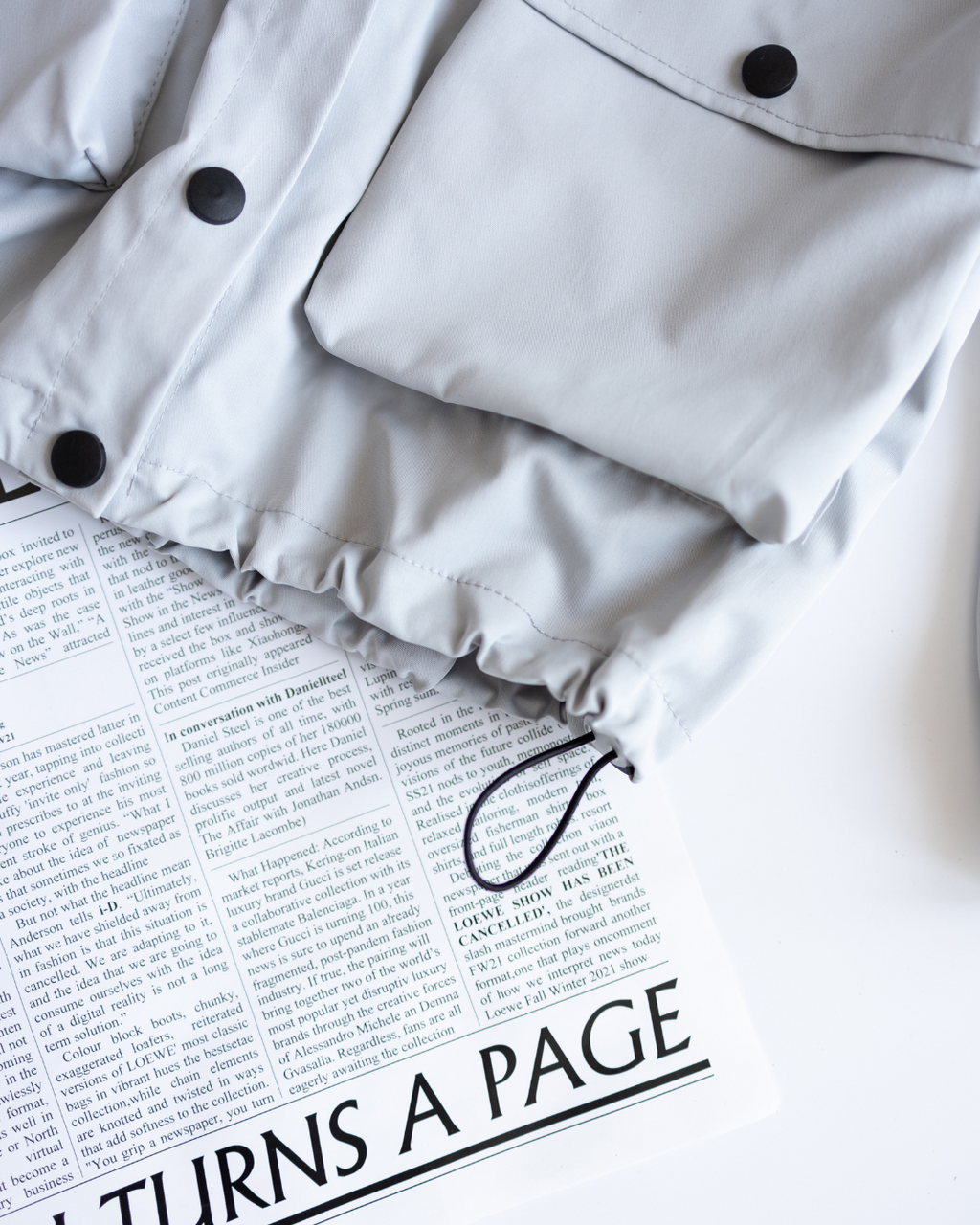 Drawstring hem detail on kids windbreaker for adjustable fit
