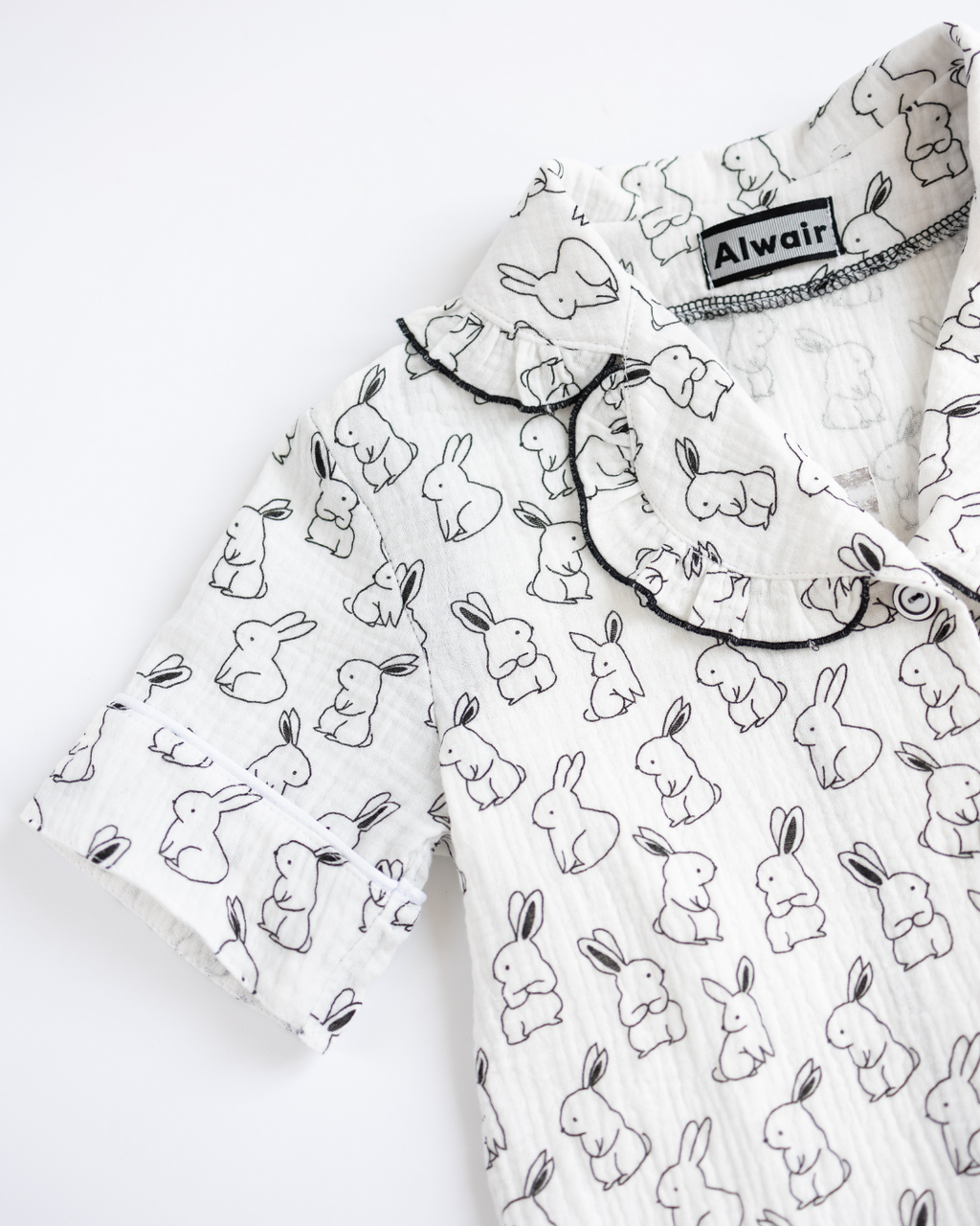 Close-up of sleeve and neckline on girls bunny print muslin pajama
