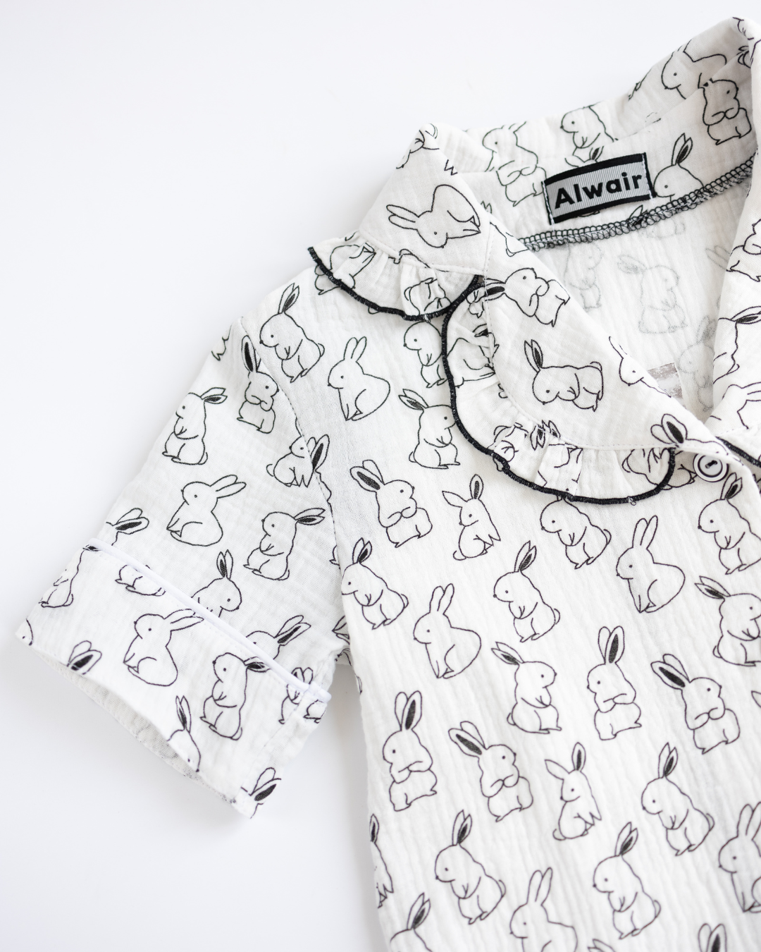 Close-up of sleeve and neckline on girls bunny print muslin pajama
