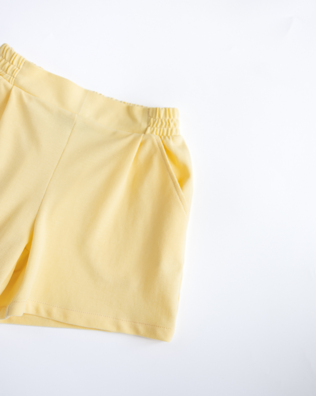 Detailed view of yellow lacoste shorts with summer fit