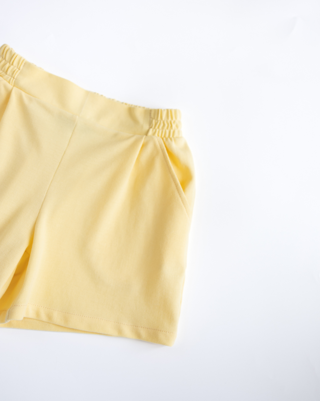 Detailed view of yellow lacoste shorts with summer fit